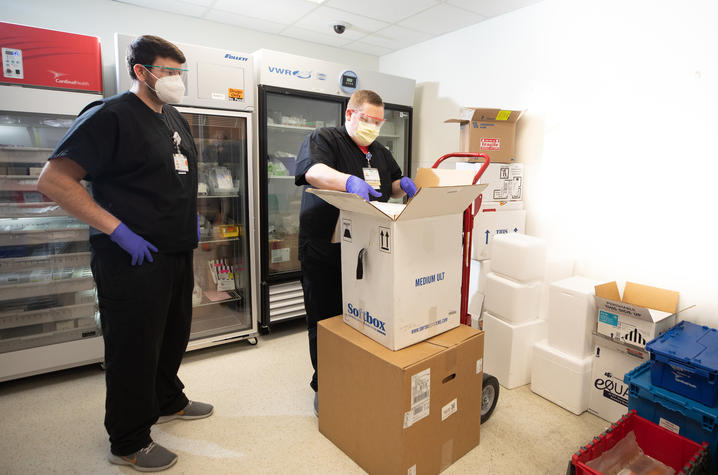 UK HealthCare Pharmacy technicians Cody Purnell and Brad Watkins with Pfizer COVID-19 vaccine mock shipment. Mark Cornelison | UK Photo