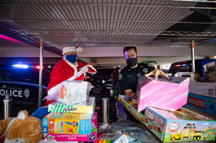 photo of UK Police Chief Joe Monroe dressed as Santa and UK Police Sgt. Wesley Tyler unloading toys for Kentucky Children's Hospital patients.