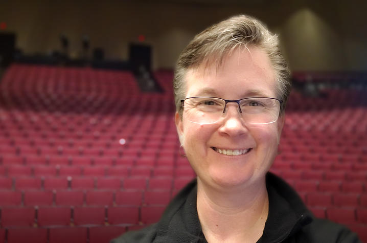 photo of Tanya Harper with Singletary Center Concert Hall seats behind her