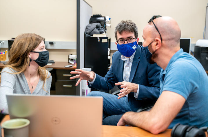 Photo of Dr. Alexandre Martin and Team of Researchers Having a Discussion