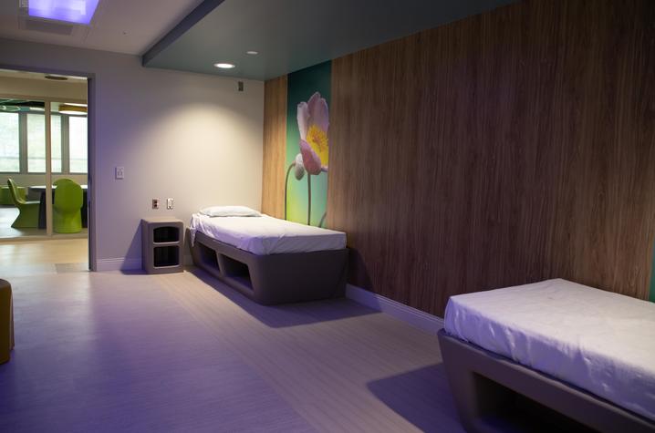 photo of patient room with two beds and adjustable color lights