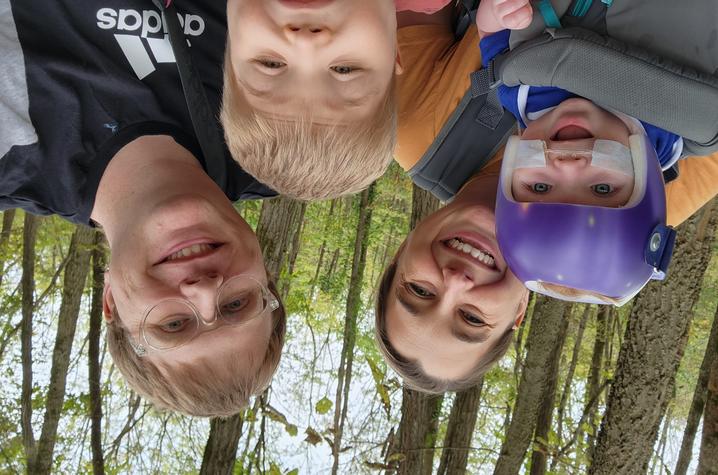 Selfie image of Polston family in the woods