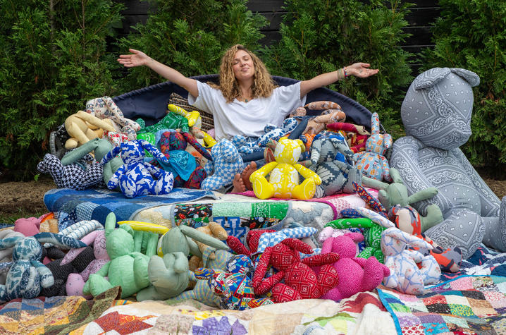 image of Caroline surrounded by the toy bunnies made for babies in the NICU