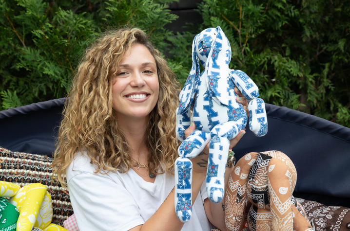 Image of Caroline holding up a vintage UK-printed toy bunny