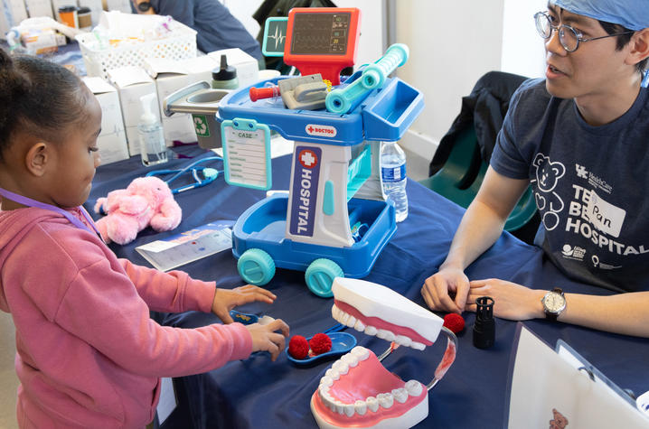 image of little girl playing with toy medical models