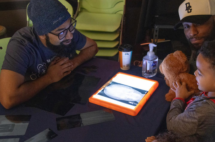 image of healthcare provider and little boy looking at x-rays