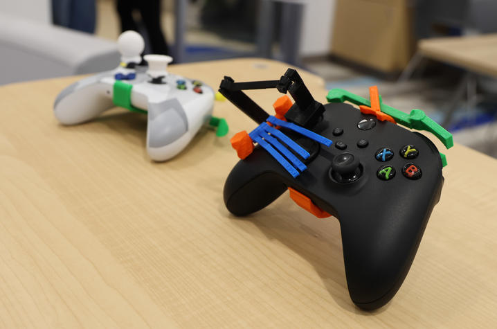 Image of gaming controllers outfitted with 3D printed assistive devices