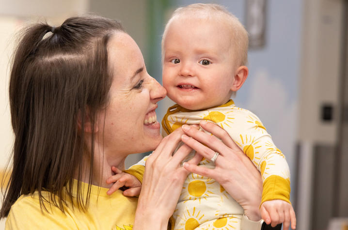 Image of Addi being held by her mother Hannah