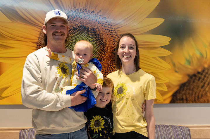 Image of Luedeke family standing in front of a sunflower