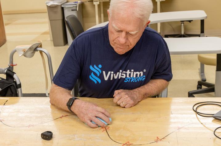 Lewis is an author and hopes to get back to using the computer efficiently. Some of his therapy sessions include tracing a line with a computer mouse and clicking on designated spots along the line. Photo by Hilary Brown.