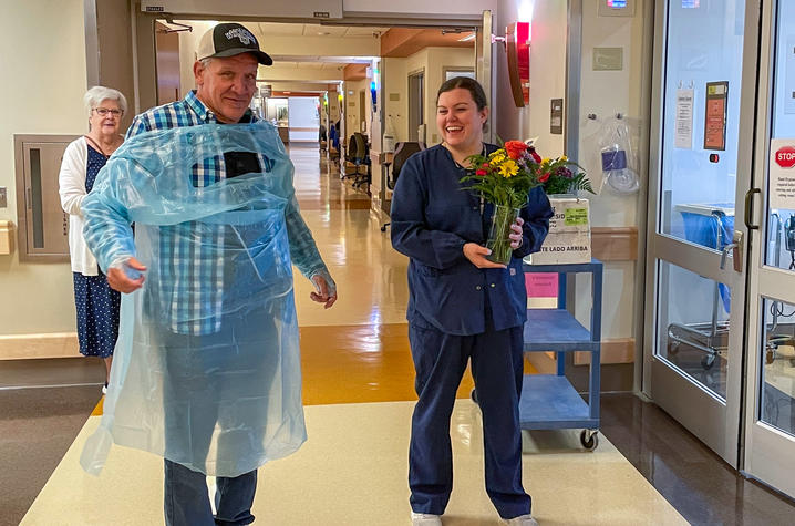 Image of Bobby with a nurse delivering flowers