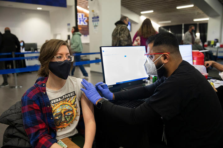 photo of student administering COVID vaccine