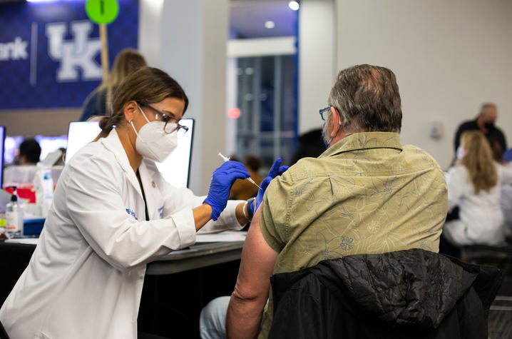 photo of student administering COVID vaccine