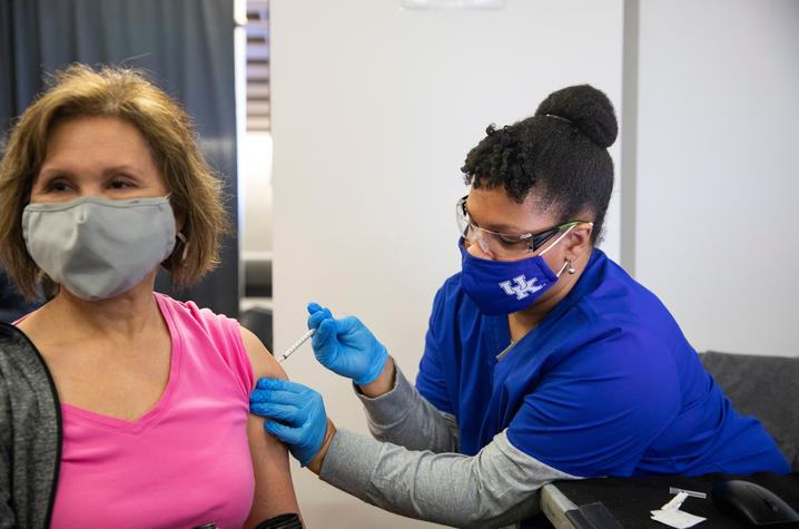 photo of student administering COVID vaccine