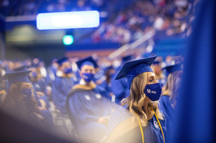 Graduates pictured at May 2021 commencement in regalia and masks