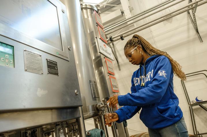 Johnna Campbell takes a sample from the blending system. Photo by Matt Barton