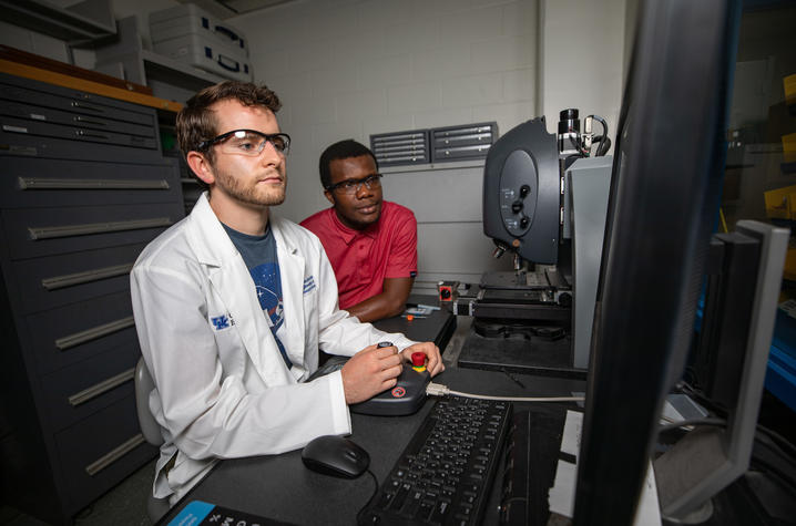 Photo of graduate research assistants doing an experiment. 