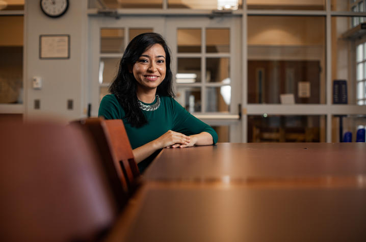 Tithi Basu-Mallik seated at conference table