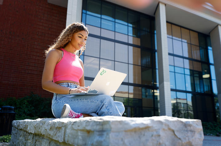 girl outside on laptop