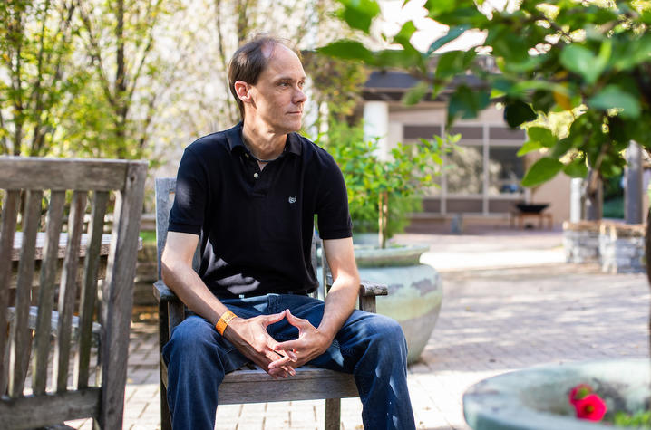 Image of Scott Kindred sitting in outdoor courtyard