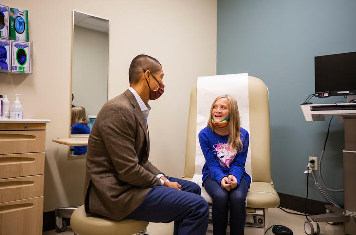 Dr. Liau chatting with patient in exam room