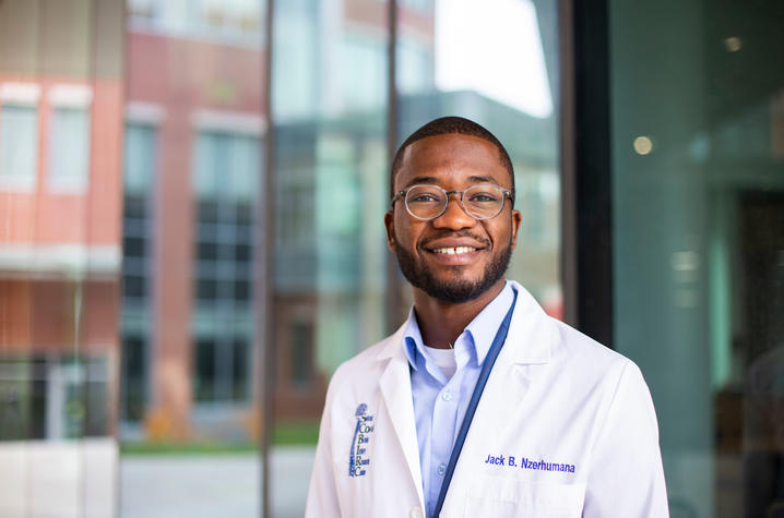 Jack Nzerhumana in white lab coat