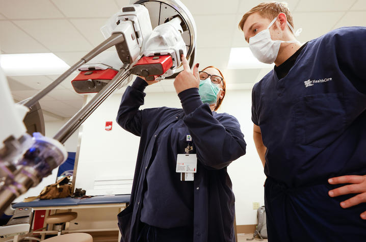 Image of two people looking at a surgery robot