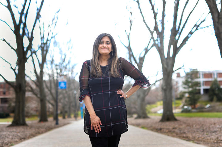 Eman Sheikh standing on campus. 