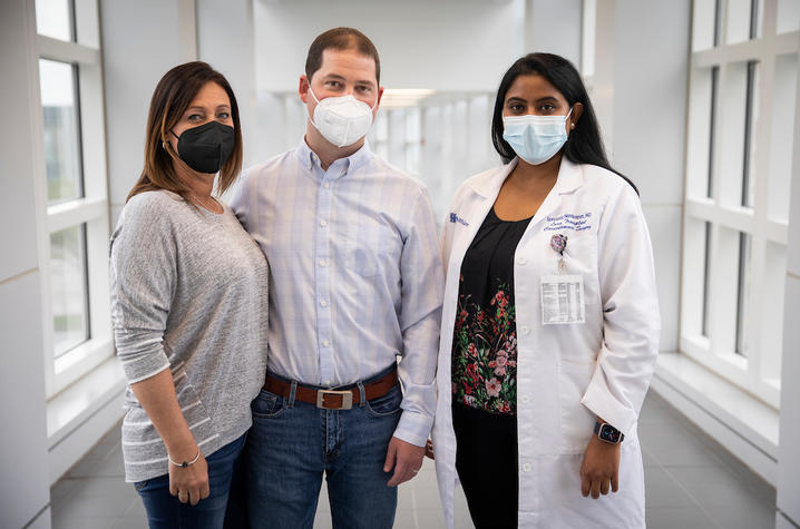 Image of Michelle Wilkins, Andy Wilkins and Sravanthi Nandavaram in glass and white corridor. 