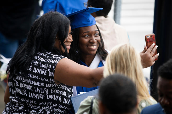 This is a photo of a new University of Kentucky graduate with her biggest fan during Commencement (May 2022).