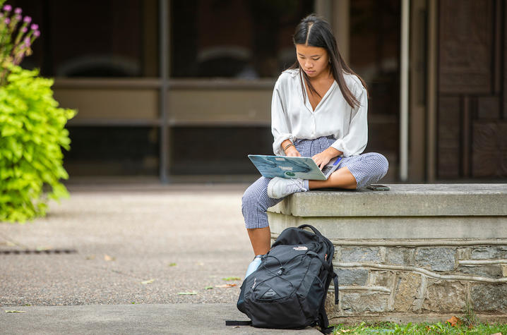 Photo of student studying on campus