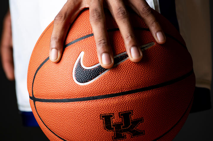 a hand holding a basketball