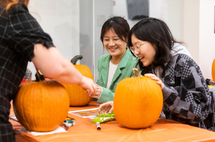 photo of students carving pumpkins