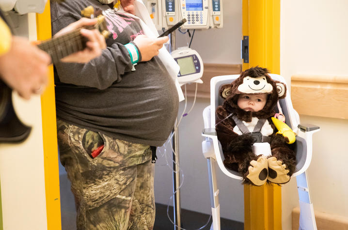 image of patient dressed in a monkey in a high chair