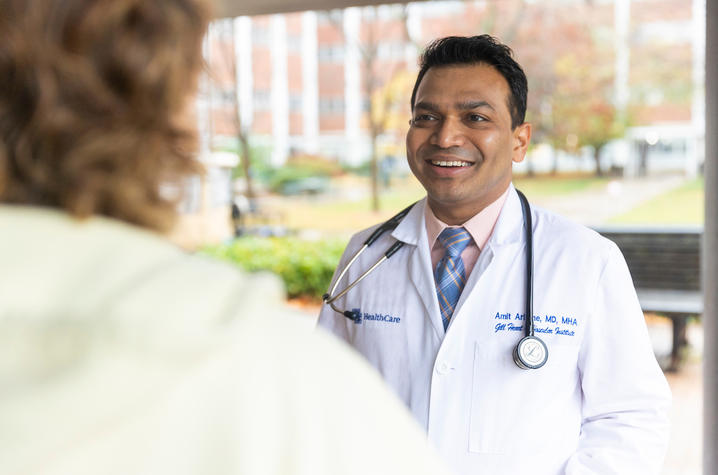 Image of Dr. Amit Arbune chatting with patient