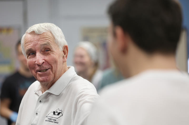 don frazier smiling and talking to a high school student