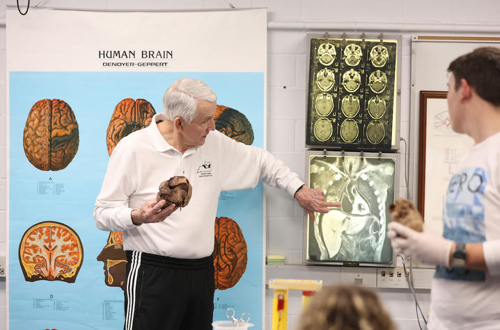 don frazier holding a human heart and showing students where it is on an X ray