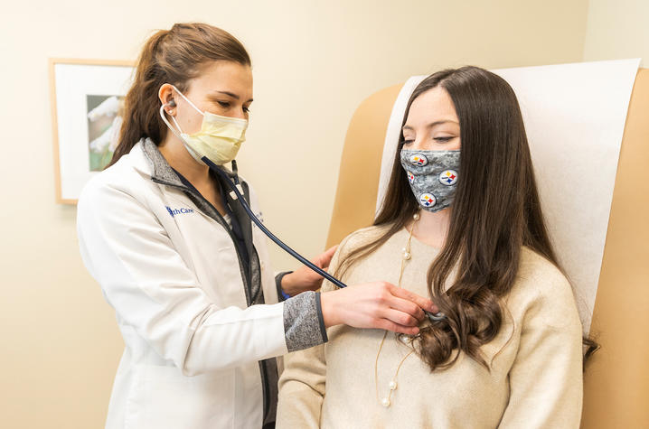 Image of Dr. Fisher listening to Abby's heart with a stethoscope