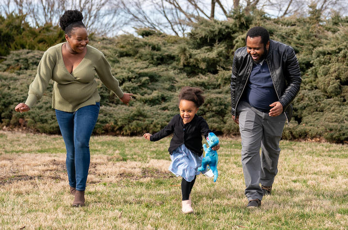 image of Sochi running through the park with her parents