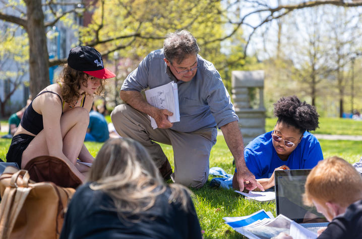 This is a photo of a faculty member teaching students outside on the UK campus. 