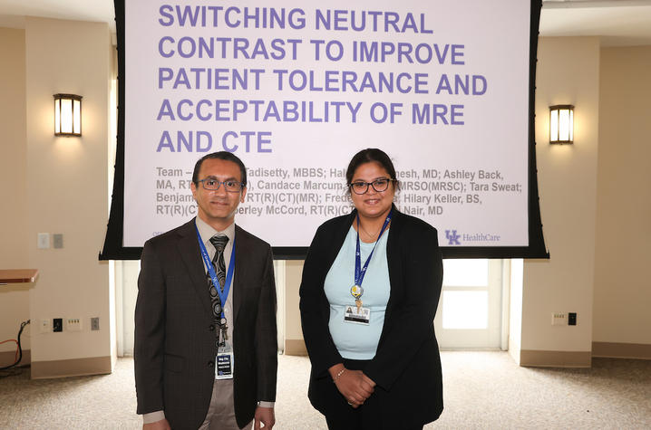 Image of two people standing in front a presentation screen