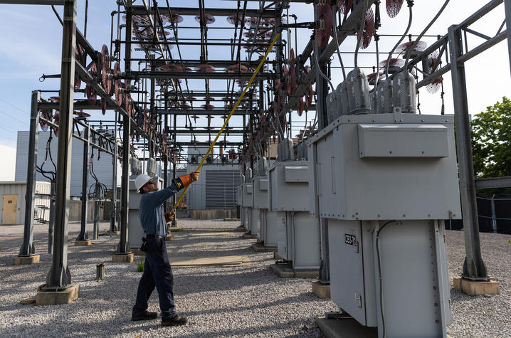 Brian Bayer, a high voltage electrician in Facilities Management, opens a switch at one of the three UK electrical substations. The 19.2% decrease in energy use per square foot includes electricity measured at a campus level at our substations.