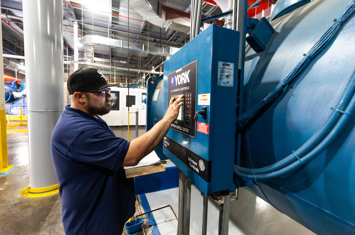 Jonathan Minton, plant operator in Facilities Management, checks the efficiency of one of six chillers at the Central Utility Plant. Plant operators must continuously monitor campus needs to make sure chilled water efficiently meets demand.