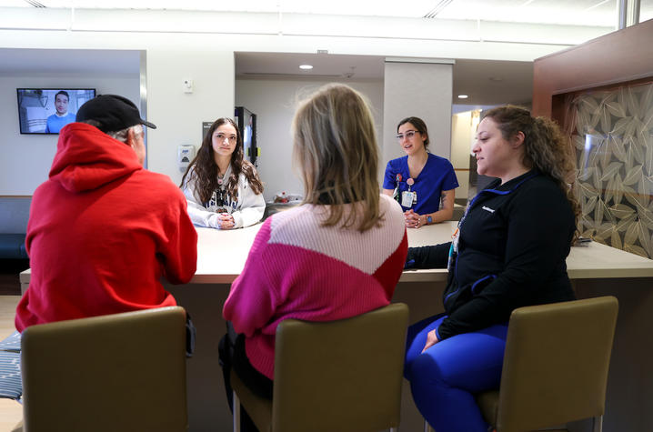 Image of Bobby talking to members of his care team