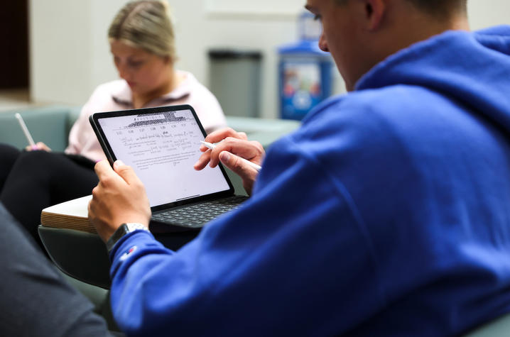 Students studying on an iPad. 