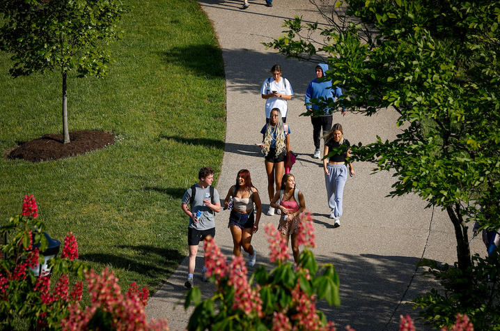 students walking outside on campus in the spring