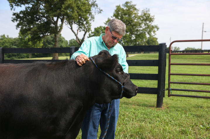 Billy Fryer poses with a cow