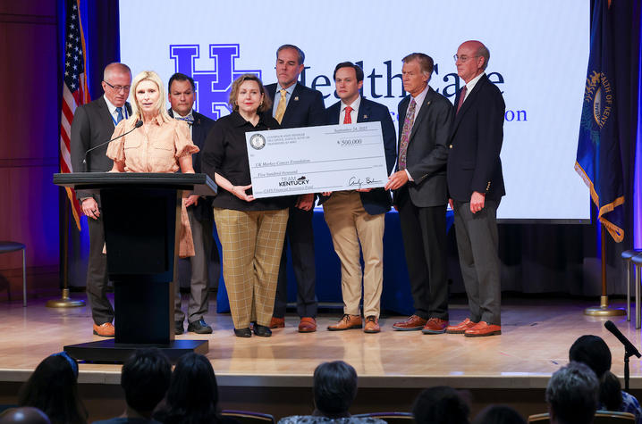 Image of physicians, legislators and advocates with a check to support cancer patients and families