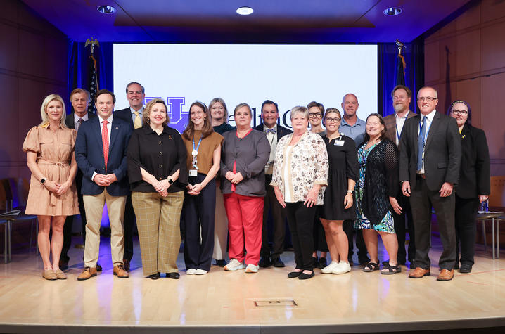 Image of physicians, legislators and advocates with a check to support cancer patients and families