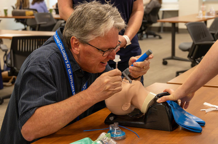 photo of providers recieving training at golisano affiliate network conference A conference attendee practices pediatric airway management on a training mannequin during a hands-on simulation session.